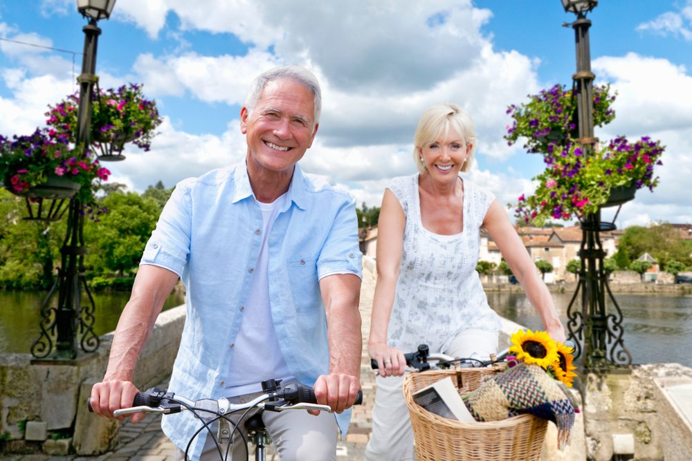 Portrait,of,mature,couple,riding,cycle,over,bridge