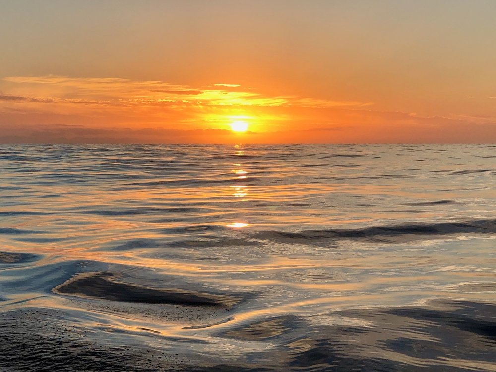 A,peaceful,ocean,scene,at,sunset,with,warm,golden,light